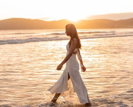 woman walking at beach Motherly